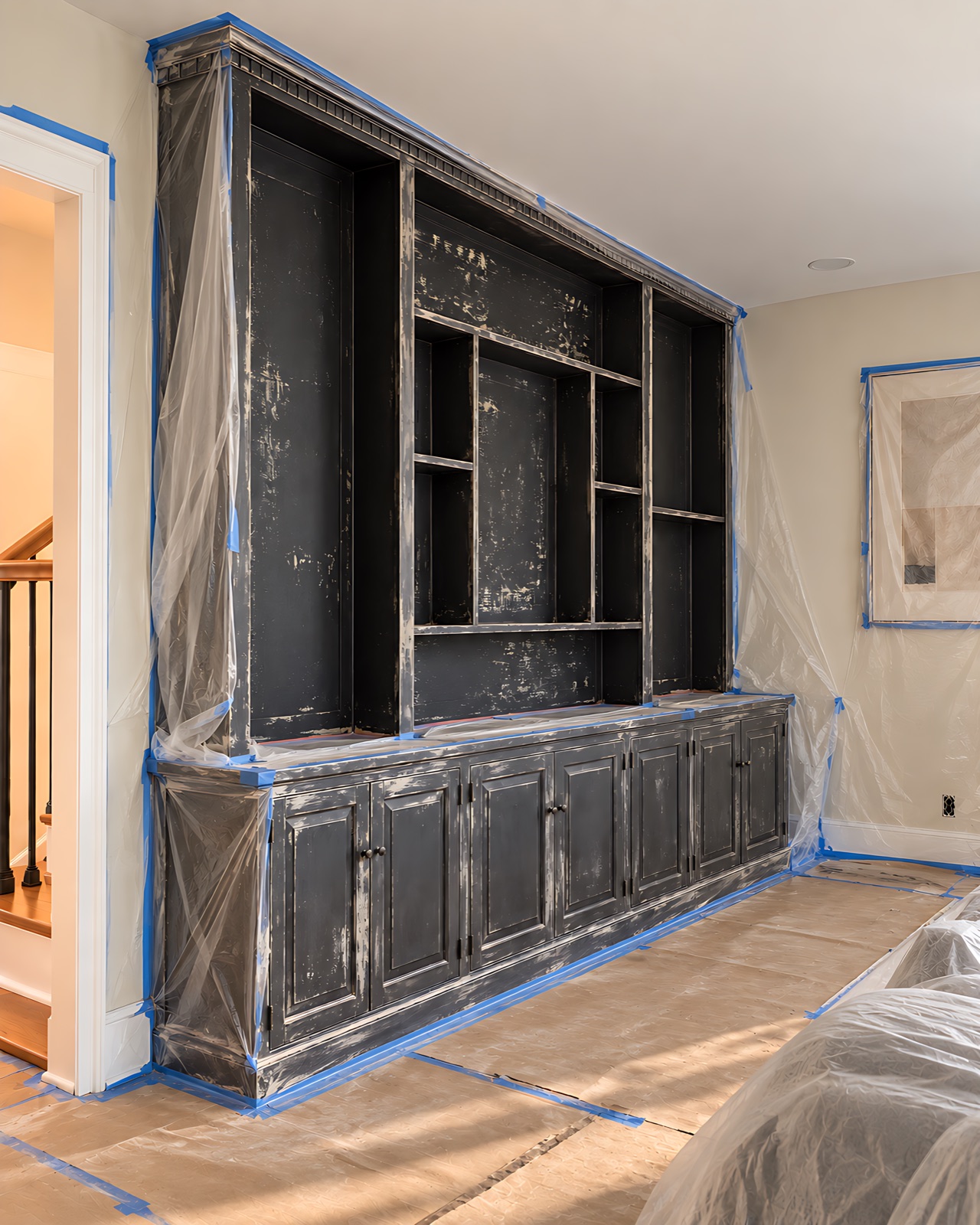 Cabinet before refinishing with surrounding surfaces protected